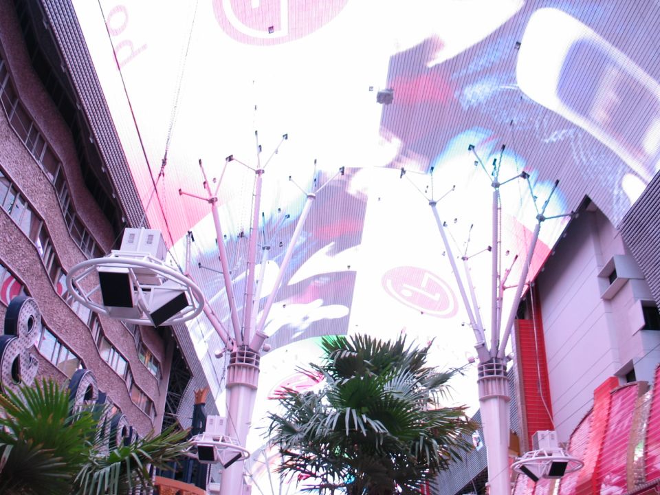 Fremont Street Experience canopy in Las Vegas, showing buildings and palm trees