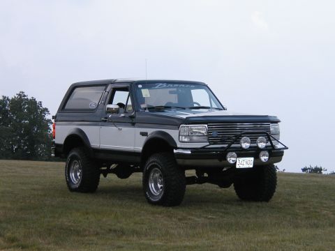 1994 Ford Bronco - This 1994 Ford Bronco features a two-tone paint scheme and an aggressive aftermarket bumper with auxiliary lights.