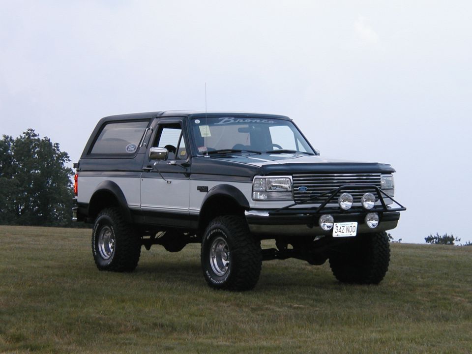 Two-tone Ford Bronco, front view, with aftermarket bumper and lights