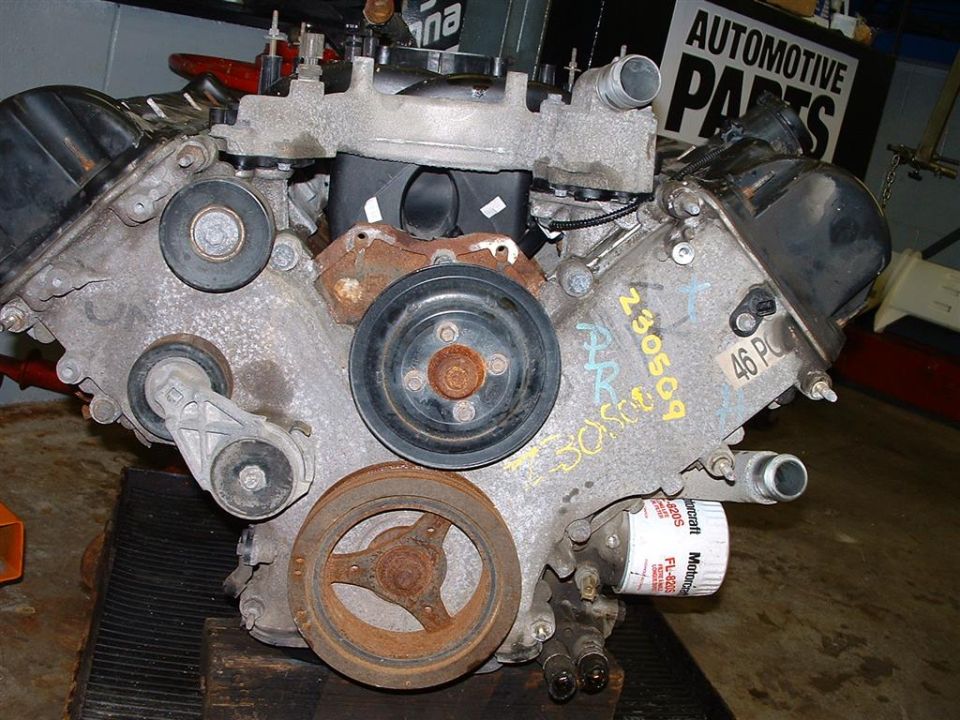 Front of a V engine with serpentine pulleys, removed crank pulley and Motorcraft FL-820 filter