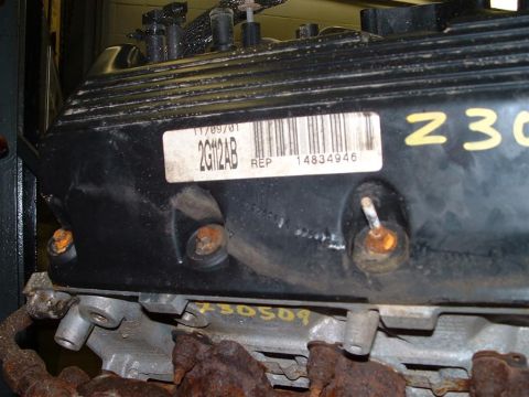 1996 Ford Crown Victoria - A close-up view of an engine component with a barcode label and part numbers.
