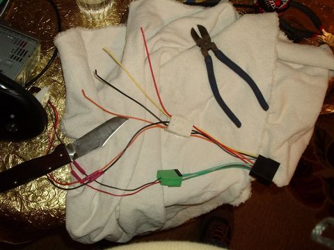 2000 Ford Taurus - Wiring harness and tools laid out for car stereo installation or modification.
