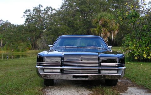 1969 Mercury Marauder - A black 1969 Mercury Marauder is parked outdoors, facing the camera, with a natural landscape behind it.
