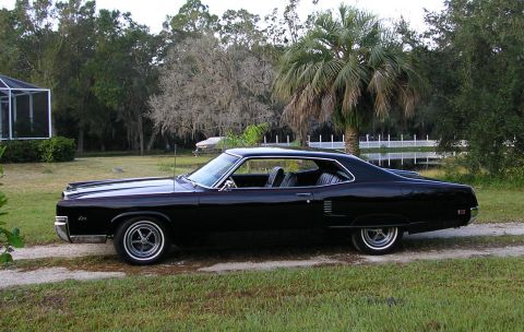 1969 Mercury Marauder - This 1969 Mercury Marauder is parked on a dirt driveway with a scenic background.