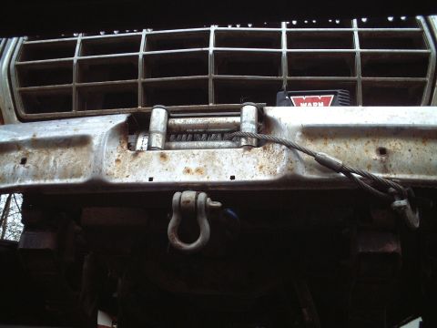 1979 Ford F-150 - Close-up of a rusty bumper and grille on a truck, a WARN winch.