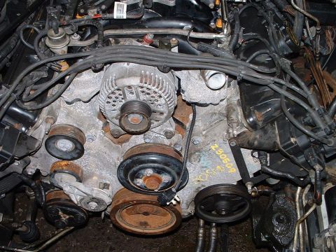 1996 Ford Crown Victoria - Engine bay of a 1996 Ford Crown Victoria showing the alternator and various pulleys. Yellow markings are present on the block.