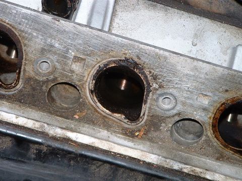1996 Ford Crown Victoria - This image shows a close-up view of an engine's exhaust port, heavily coated with carbon deposits.