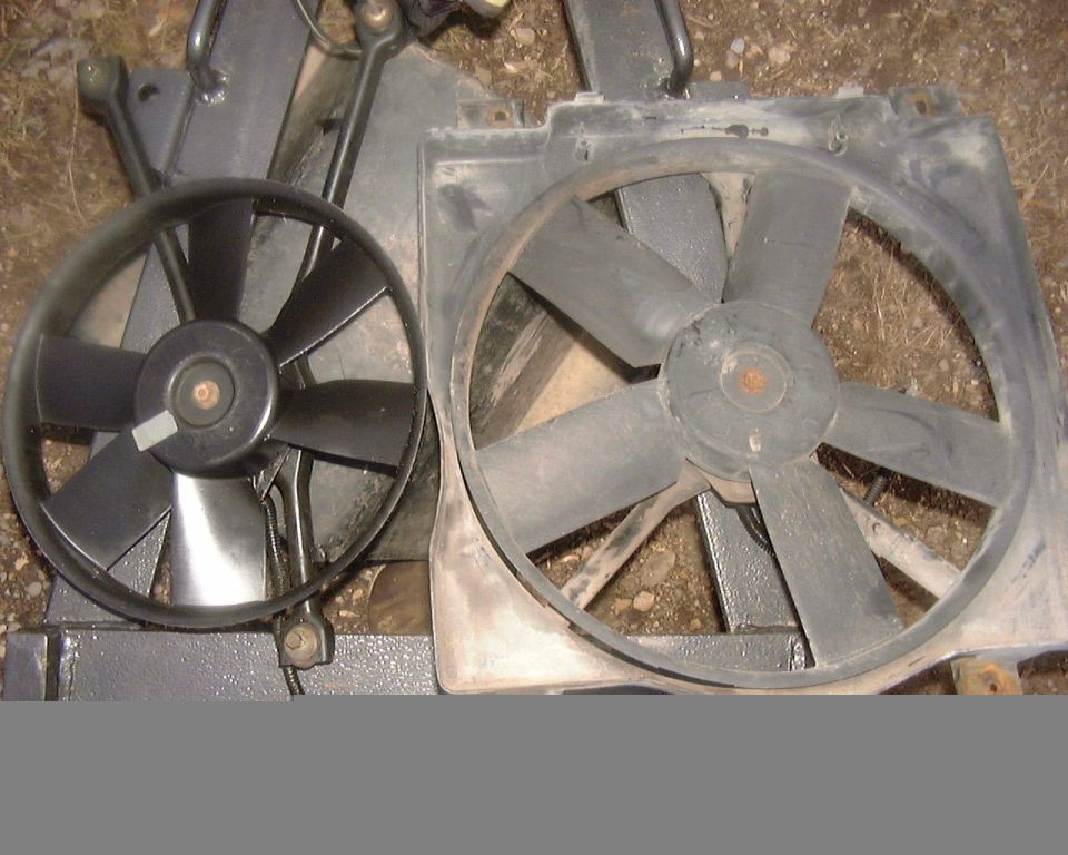 Two black radiator fans, one smaller than the other, mounted on metal frames