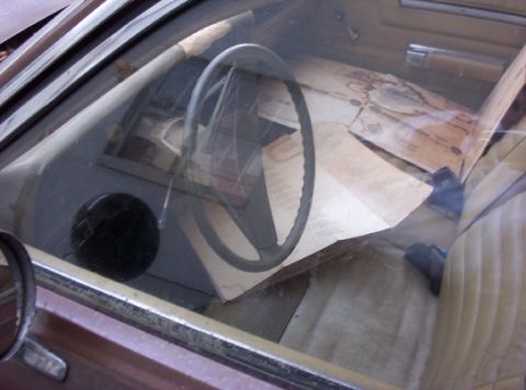 1991 Ford LTD Crown Victoria - Car interior with papers scattered across the dashboard and seats.