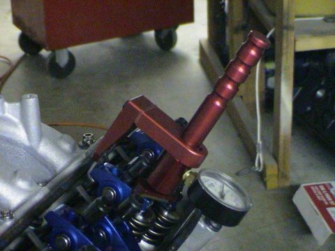 1979 Ford Bronco - A red valve spring compressor tool with a pressure gauge is shown attached to engine components.