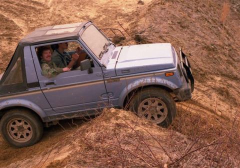 1991 Ford Bronco - Suzuki Samurai tackling rough terrain off-road.