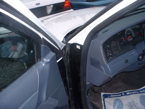 1999 Ford Crown Victoria - The dashboard and interior of a 1998 Ford Crown Victoria are visible, with another vehicle in the background.