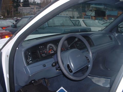 1999 Ford Crown Victoria - Interior view of a 1999 Ford Crown Victoria, showing the dashboard, steering wheel, and surrounding cabin.