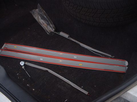 1999 Ford Crown Victoria - Unidentified car trim pieces and wiring are stored in the trunk of a vehicle.