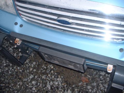 1999 Ford Crown Victoria - Close-up of a Ford vehicle's front end, showing the grille and bumper area.