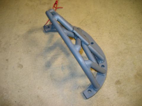 1985 Ford Bronco - A single gray metal component, possibly a bracket or frame piece, is shown with a red string tied to it.