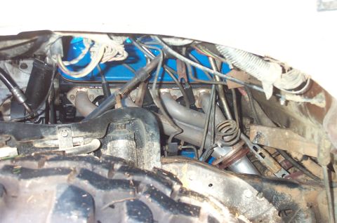 1987 Ford Bronco - Close-up view of an engine compartment headers and a blue valve cover.