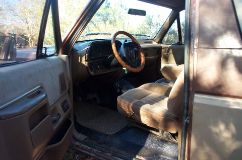 1987 Ford Bronco - Interior view of a 1987 Ford Bronco, tan upholstery and dashboard details.