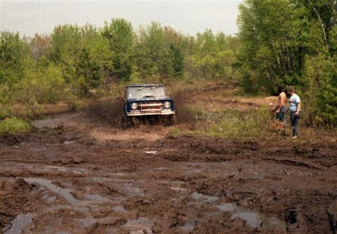 1991 Ford Bronco - First-gen Ford Bronco navigates a challenging muddy off-road course.