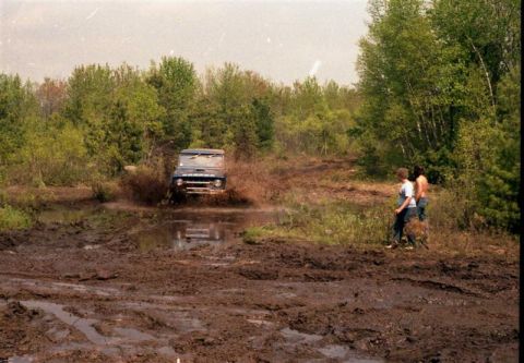 1991 Ford Bronco - Ford Bronco navigates a challenging muddy off-road course.