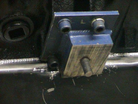 1979 Ford Bronco - Close-up of a blue engine mount bracket, likely part of an engine build.