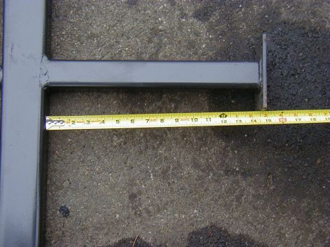 1991 Ford Bronco - A tape measure is shown alongside a gray metal slider bar, indicating its dimensions on a paved surface.