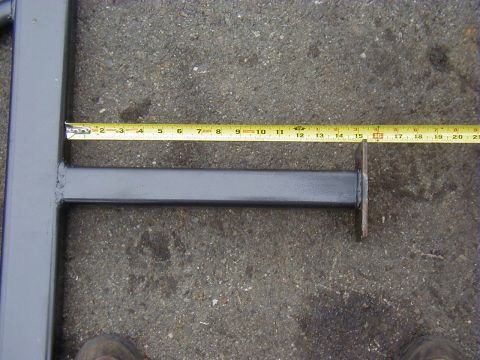 1991 Ford Bronco - A metal slider bar is measured with a tape measure.