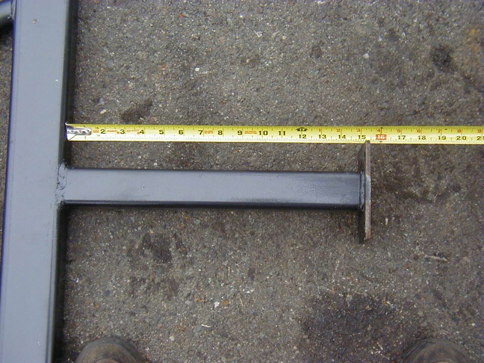 Gray metal slider bar with tape measure showing 15 inches
