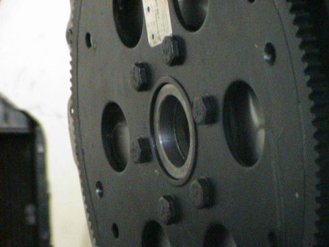 1979 Ford Bronco - Flywheel part with bolts and a tag, likely from an engine assembly.