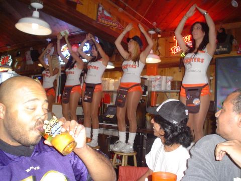 1993 Ford Taurus - People enjoying drinks and entertainment at a Hooters restaurant.