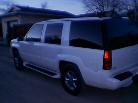 1999 Cadillac Escalade - White 1999 Cadillac Escalade parked outside a house during twilight.