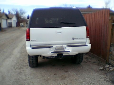 1999 Cadillac Escalade - Rear view of a white 1999 Cadillac Escalade parked outdoors.