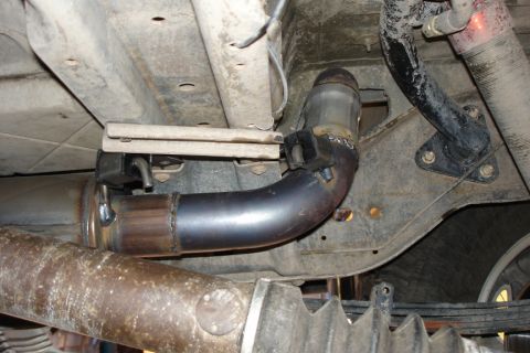 1987 Ford Bronco - Close-up view of the exhaust system on a 1987 Ford Bronco, highlighting a recent repair.