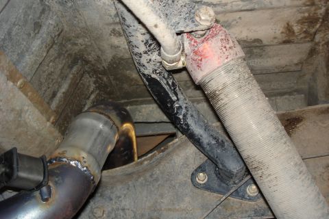 1987 Ford Bronco - Underbody view of a vehicle's exhaust system, showing a recently welded pipe and a flexible hose.
