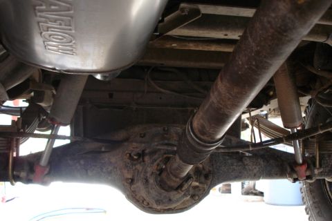 1987 Ford Bronco - Underside view shows rear axle, differential, and exhaust system with 'FLOWMASTER' branding.