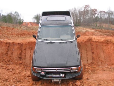 1986 Ford F-150 - This Toyota truck appears to be stuck in a deep dirt ditch, its front winch engaged.