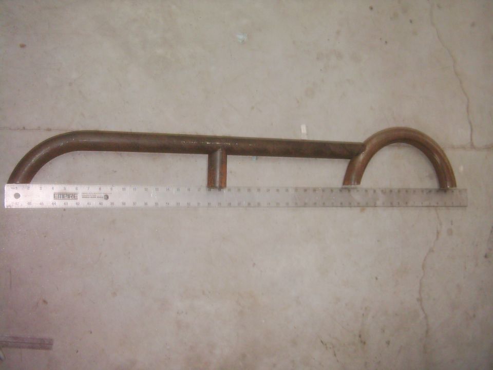 Metal rock slider part with ruler for scale. Supermotors.net logo visible