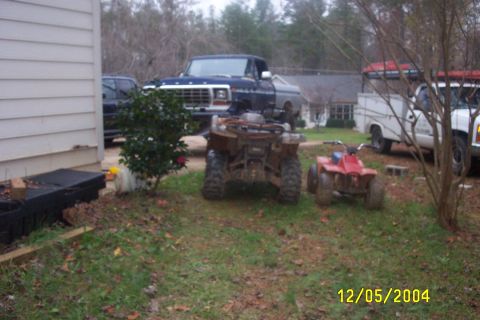 1979 Ford F-150 - A 1979 Ford F-150 pickup truck is parked in a yard with several ATVs and another truck.