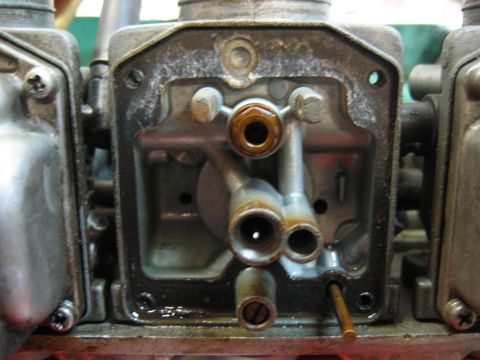1985 Ford LTD Crown Victoria - The internal workings of a carburetor are visible in this close-up shot.
