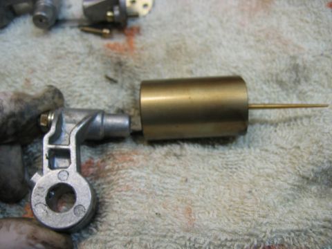 1985 Ford LTD Crown Victoria - Close-up of a carburetor float needle and seat assembly, likely for a vintage vehicle, resting on a towel.