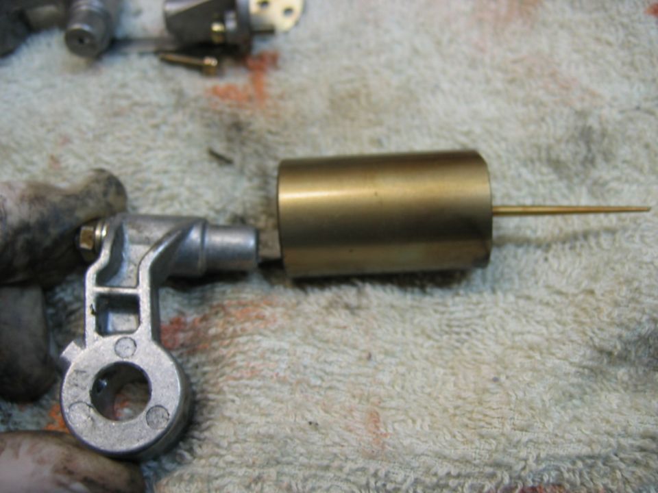 Carburetor float needle and seat assembly on a towel