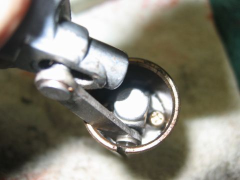 1985 Ford LTD Crown Victoria - Interior view of a distributor cap, showing internal components like an arm and screw.