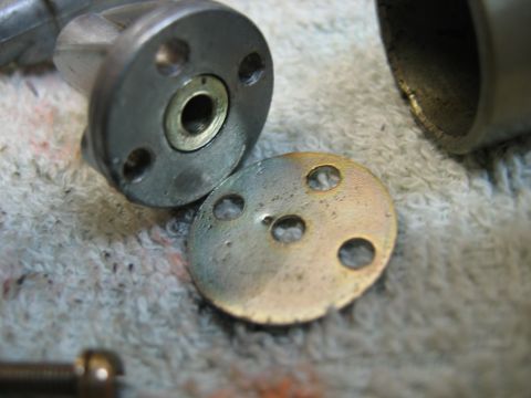 1985 Ford LTD Crown Victoria - Disassembled carburetor parts are shown on a textured cloth surface.