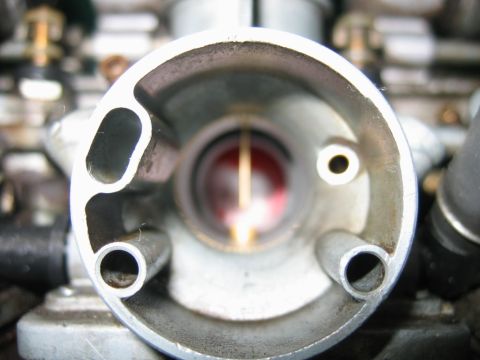 1985 Ford LTD Crown Victoria - A detailed view inside a carburetor, revealing its internal components and passages.