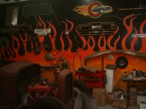 1978 Ford Bronco - A garage scene displays a flame mural, various car parts, and a vintage vehicle under restoration.