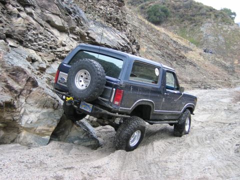 1985 Ford Bronco - This 1985 Ford Bronco is navigating a challenging off-road course with steep rocky inclines.