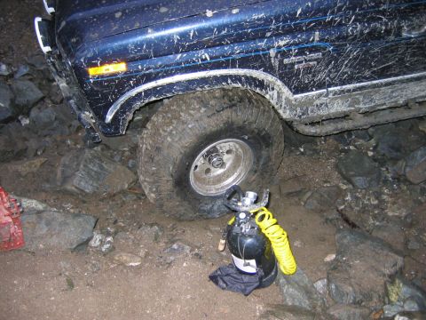 1985 Ford Bronco - This 1985 Ford Bronco appears to be stuck on a rocky trail, with an air compressor nearby.