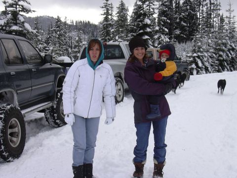 1991 Ford Bronco - A family enjoys a snowy day with their vehicles and dogs in a wooded area.