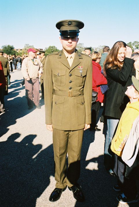 1994 Ford Bronco - A US Marine in dress uniform stands at attention while civilians observe.