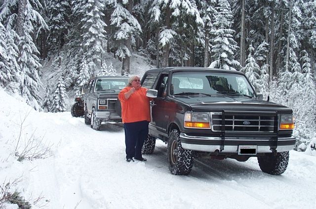 Black 1995 Ford Bronco in snow with another SUV behind it